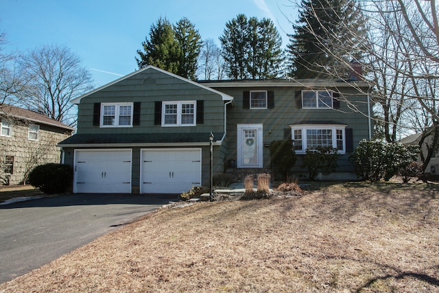 view of front of property with aphalt driveway and an attached garage