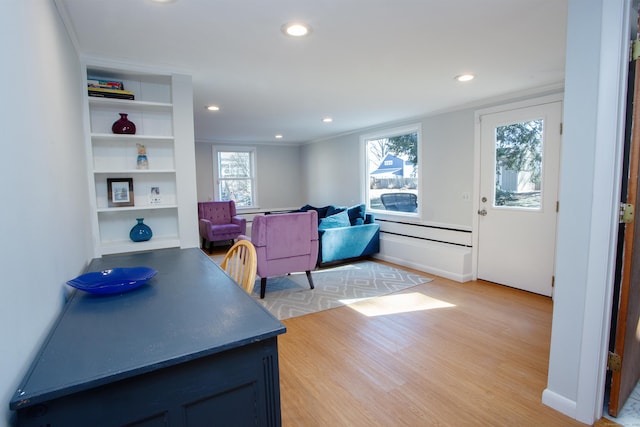 interior space featuring light wood-type flooring, a baseboard heating unit, baseboards, and recessed lighting