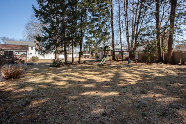 view of yard featuring fence and playground community