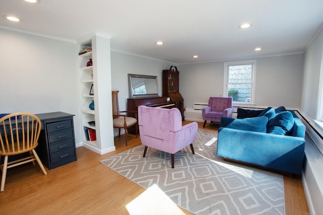 living room featuring recessed lighting, a baseboard heating unit, light wood-style floors, and crown molding