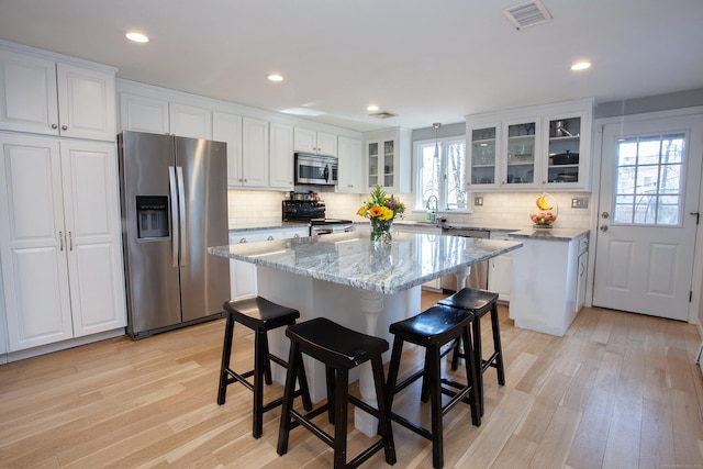 kitchen featuring light wood-type flooring, visible vents, appliances with stainless steel finishes, and white cabinets