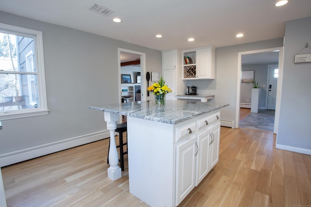 kitchen featuring open shelves, visible vents, light wood-style flooring, and recessed lighting