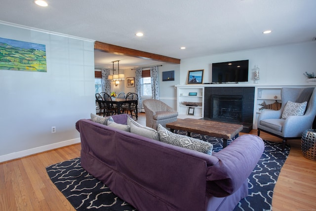 living room with a fireplace, recessed lighting, wood finished floors, and baseboards