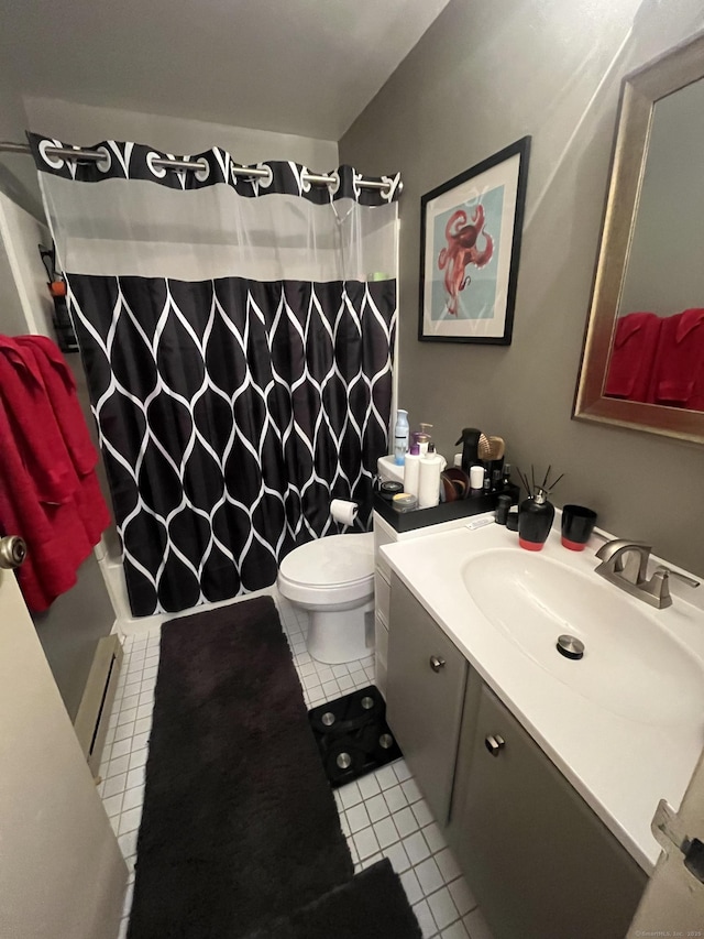 bathroom with tile patterned flooring, toilet, vanity, and a baseboard radiator