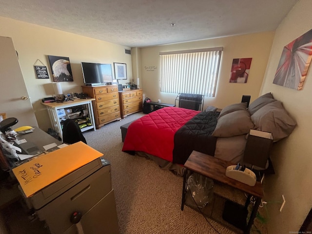 bedroom with visible vents, carpet, and a textured ceiling