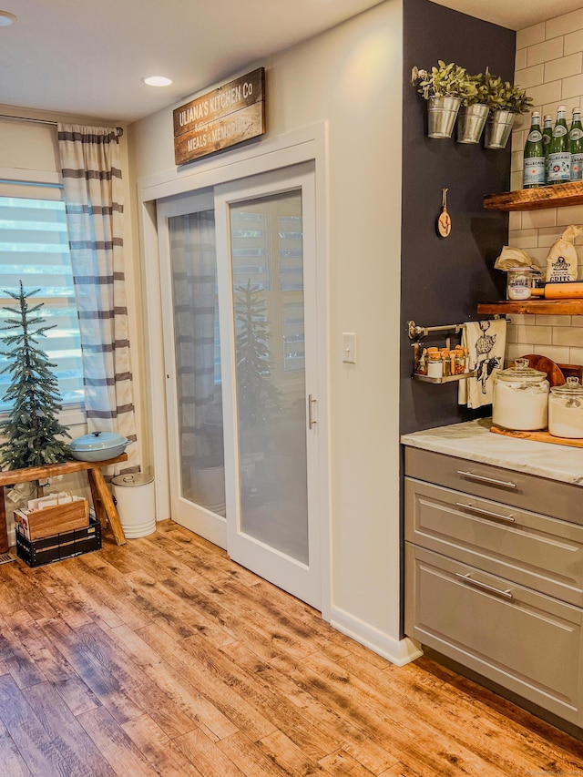 entryway featuring light wood-style flooring and baseboards