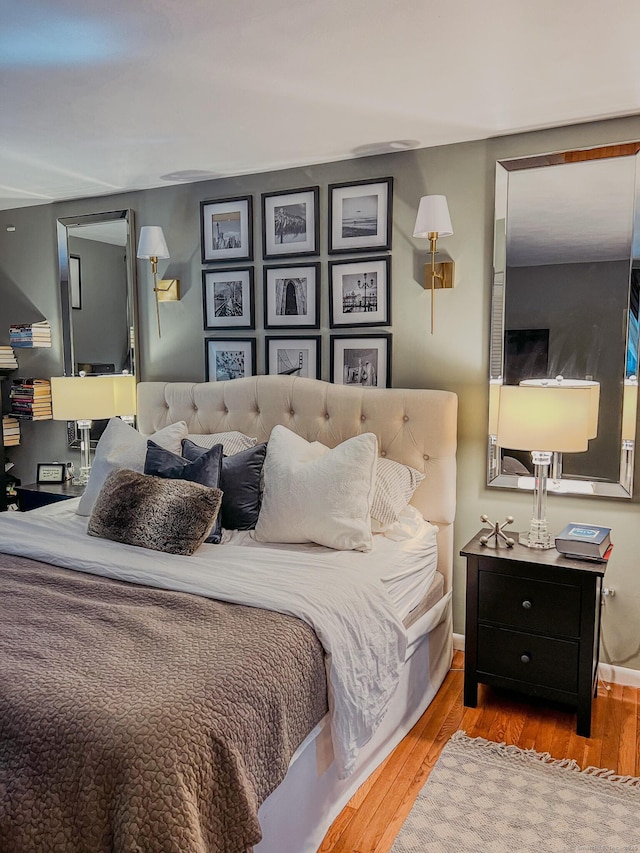 bedroom with wood finished floors and baseboards