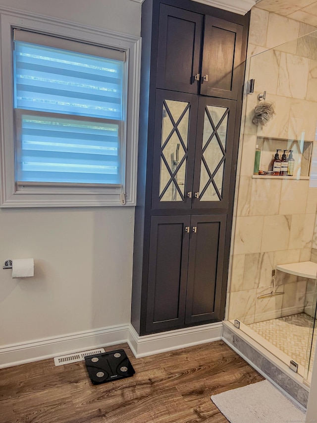 doorway featuring visible vents, dark wood-type flooring, and baseboards