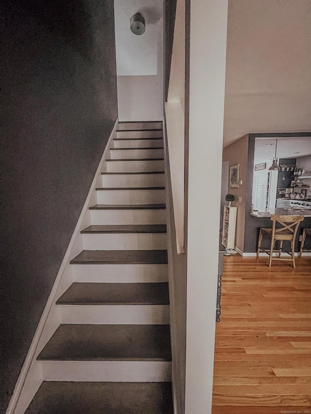 stairway featuring wood finished floors