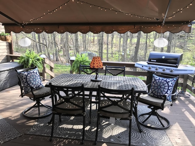 view of patio with a deck, outdoor dining area, and grilling area