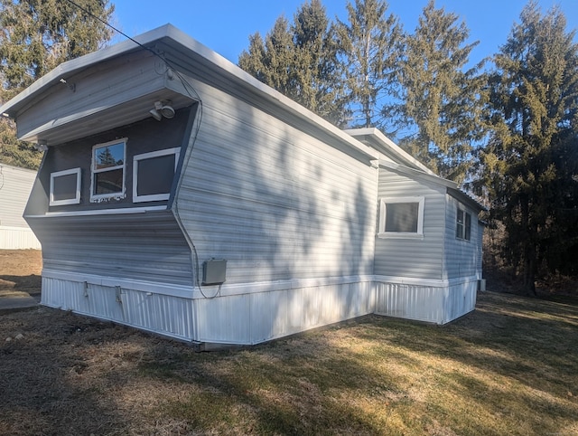 view of side of property with a lawn