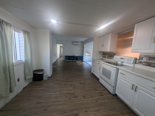 kitchen with dark wood-type flooring, white cabinets, light countertops, and white range with electric stovetop