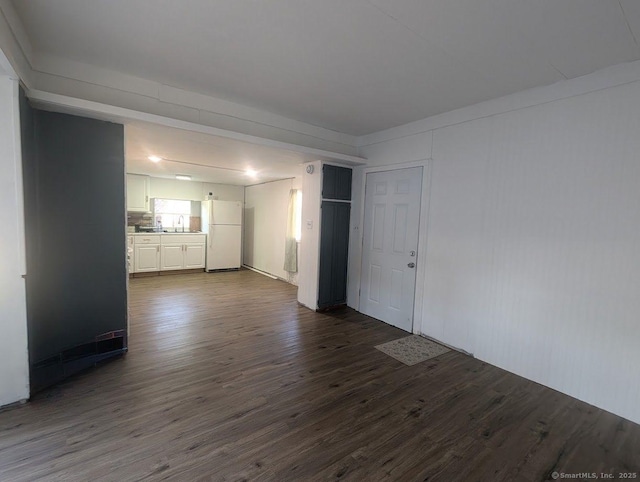 empty room with a sink and dark wood-style flooring