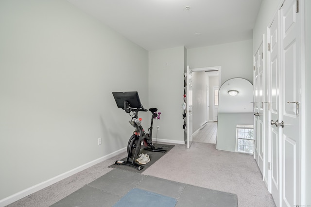 workout room with baseboards and carpet floors