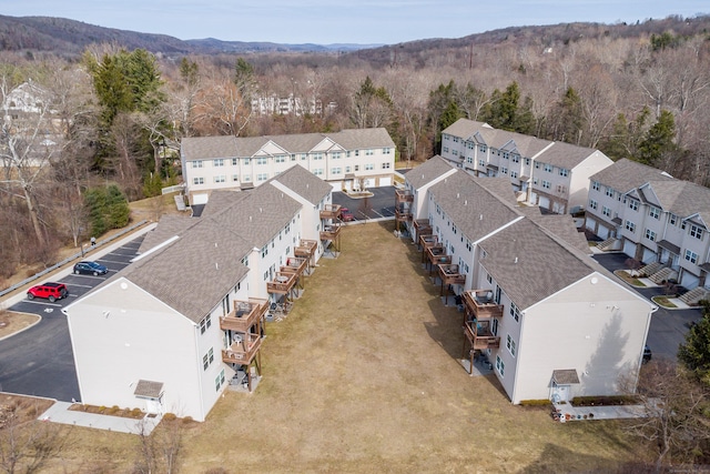 drone / aerial view with a residential view, a mountain view, and a view of trees