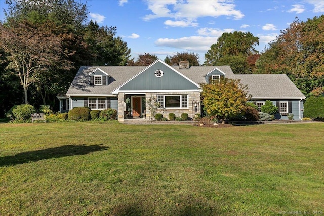 view of front of home with a front yard and stone siding