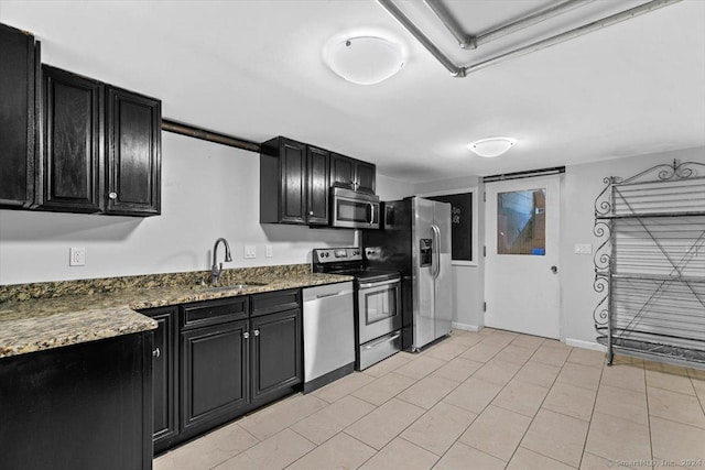 kitchen with a sink, dark cabinets, and stainless steel appliances