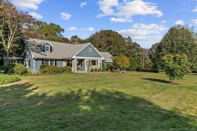 exterior space featuring a lawn and stone siding