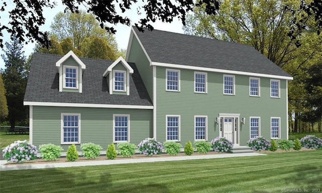 colonial-style house featuring a front yard and roof with shingles