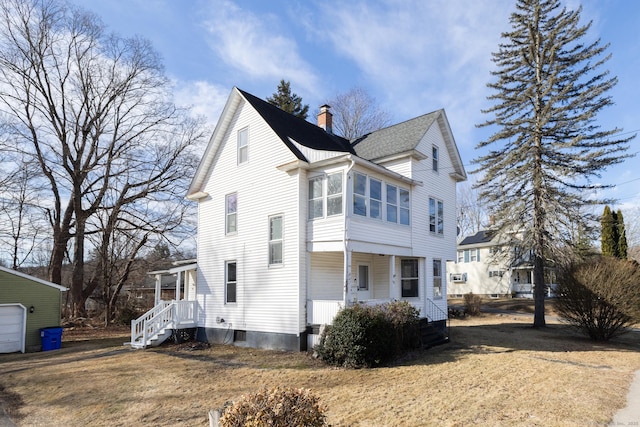 view of home's exterior featuring roof with shingles, a porch, and a chimney