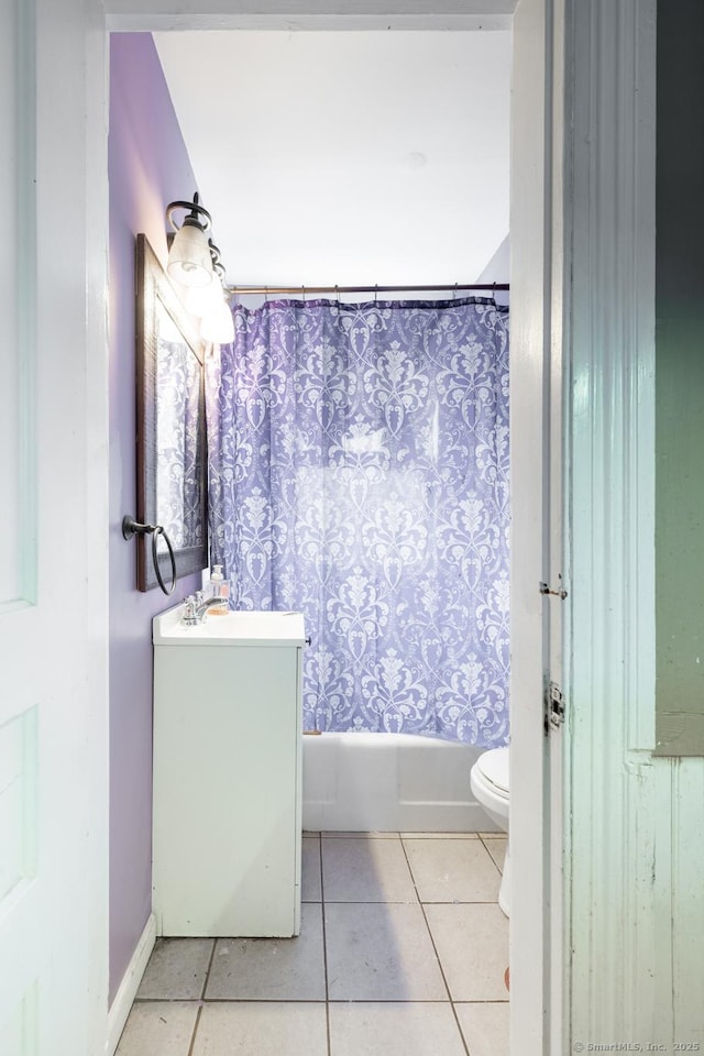 full bath featuring vanity, tile patterned floors, toilet, and shower / bath combo with shower curtain