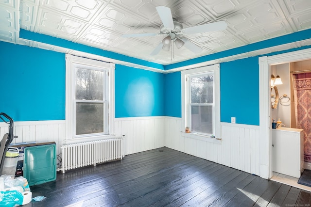 spare room with wainscoting, an ornate ceiling, and radiator heating unit