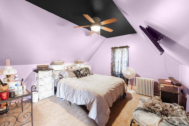 bedroom featuring ceiling fan, radiator, lofted ceiling, and carpet