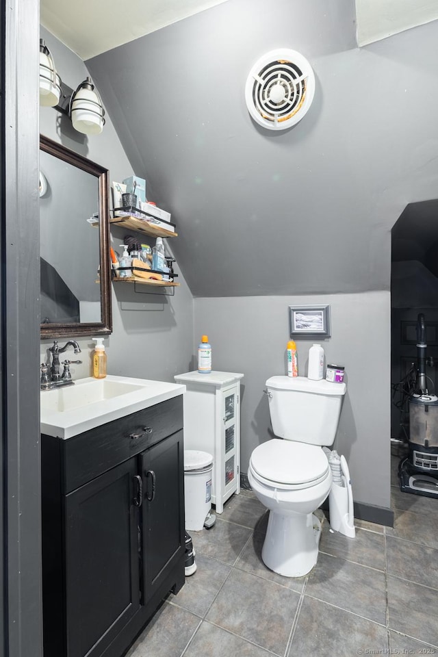 bathroom featuring visible vents, lofted ceiling, toilet, and vanity