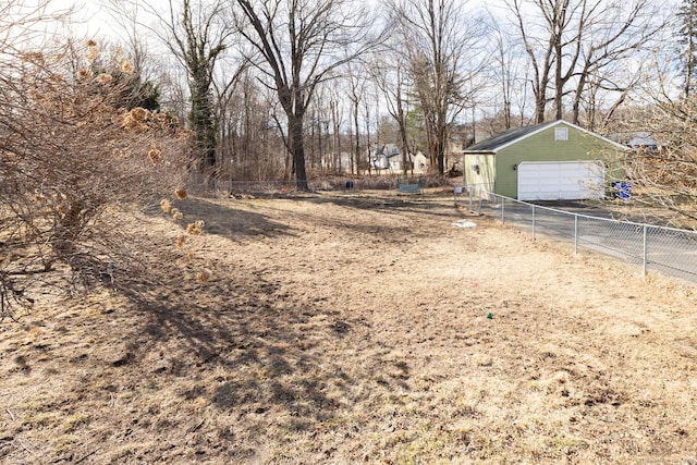 view of yard featuring an outdoor structure and fence