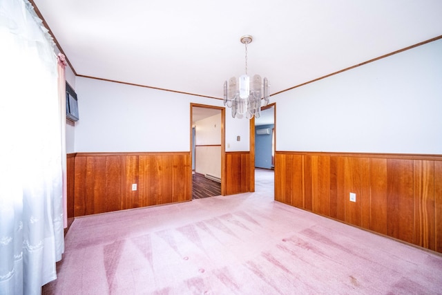 27 Mountain View Dr, East Hartford, CT 06117 - empty room featuring a chandelier, wainscoting, wooden walls, crown molding, and carpet floors