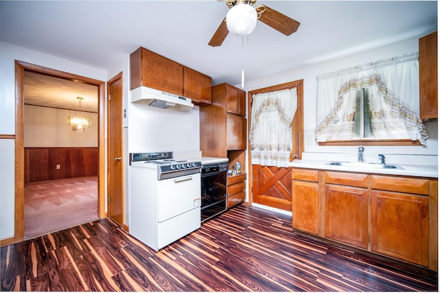 27 Mountain View Dr, East Hartford, CT 06117 - kitchen with white stove, under cabinet range hood, dark wood-type flooring, brown cabinets, and ceiling fan