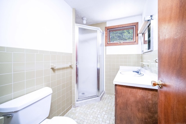 27 Mountain View Dr, East Hartford, CT 06117 - full bathroom featuring tile walls, vanity, tile patterned floors, a stall shower, and a wainscoted wall