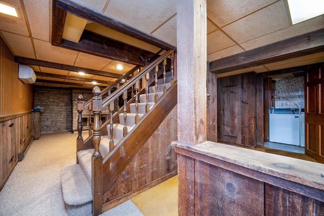 27 Mountain View Dr, East Hartford, CT 06117 - stairway with wood walls, washing machine and dryer, an AC wall unit, and carpet flooring