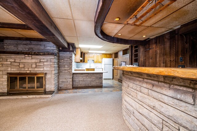 27 Mountain View Dr, East Hartford, CT 06117 - bar with freestanding refrigerator, carpet floors, and a stone fireplace