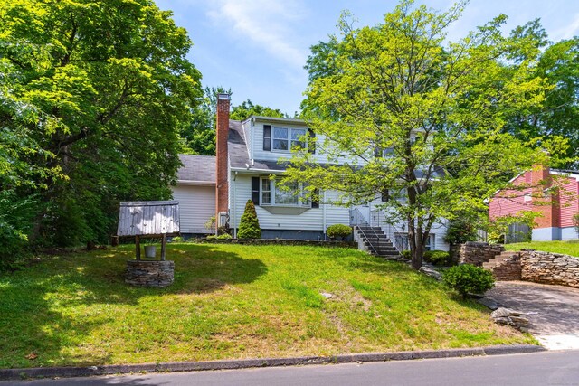 27 Mountain View Dr, East Hartford, CT 06117 - view of front of property featuring a chimney, a front yard, and stairs
