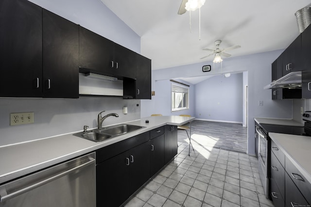 kitchen with under cabinet range hood, light countertops, appliances with stainless steel finishes, dark cabinetry, and a sink