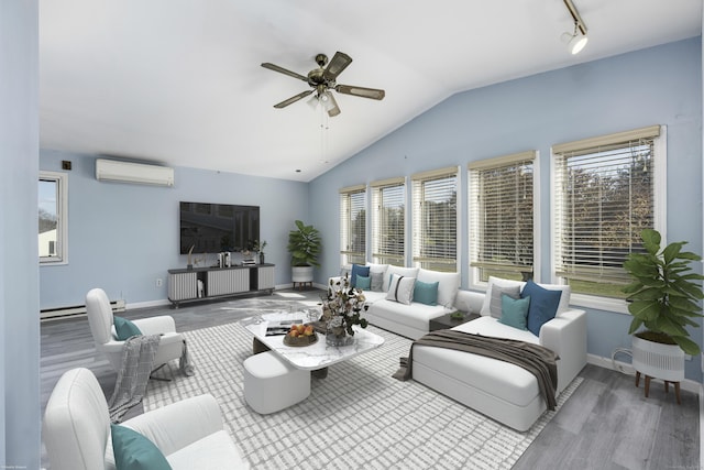 living area featuring a wall mounted air conditioner, baseboards, lofted ceiling, and wood finished floors