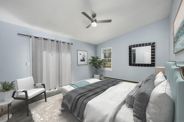 bedroom featuring a baseboard radiator, wood finished floors, a ceiling fan, and vaulted ceiling