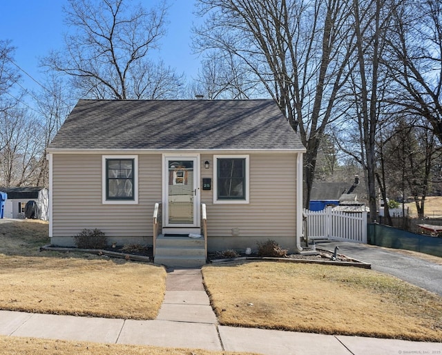 bungalow-style home with a shingled roof