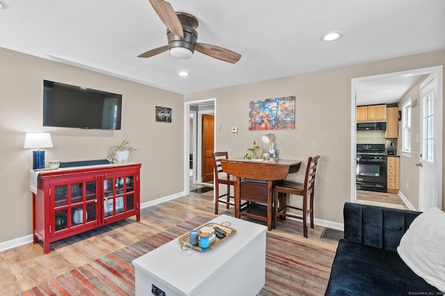 living room featuring recessed lighting, baseboards, wood finished floors, and a ceiling fan