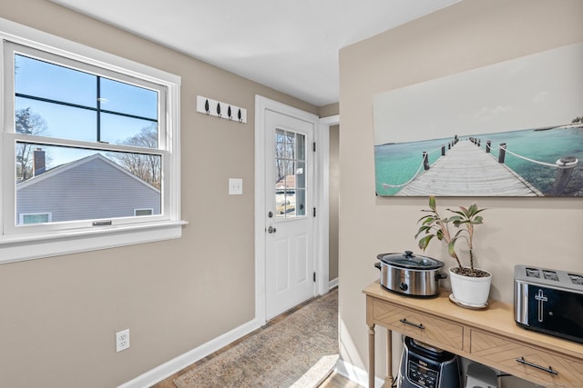 entryway featuring baseboards