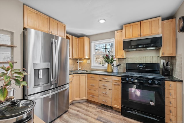 kitchen with light brown cabinetry, backsplash, stainless steel appliances, and light wood-type flooring