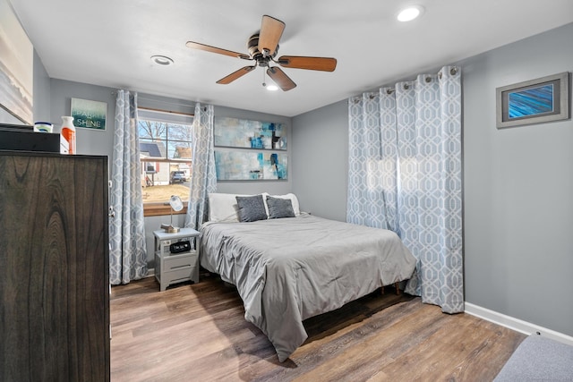 bedroom featuring recessed lighting, a ceiling fan, baseboards, and wood finished floors