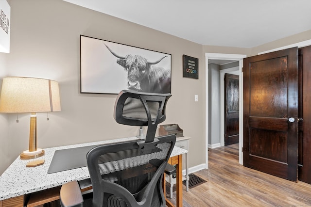 office featuring light wood-style floors and baseboards