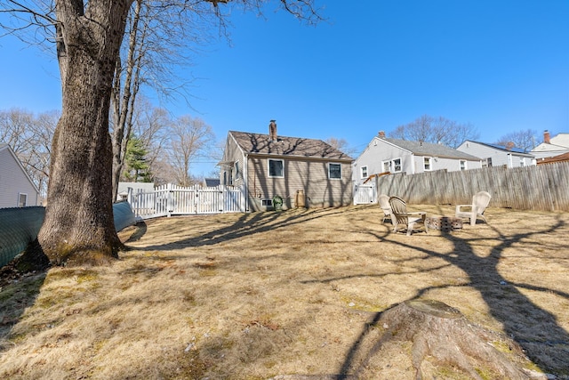 view of yard featuring a fenced backyard and an outdoor fire pit