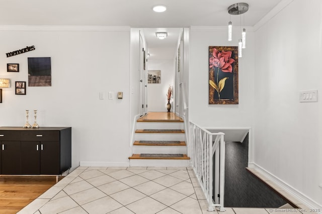 staircase featuring baseboards, wood finished floors, and crown molding