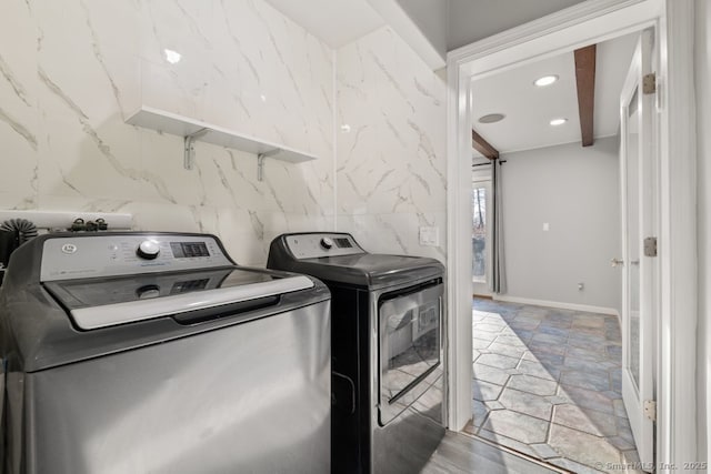 washroom with recessed lighting, washing machine and dryer, laundry area, and baseboards