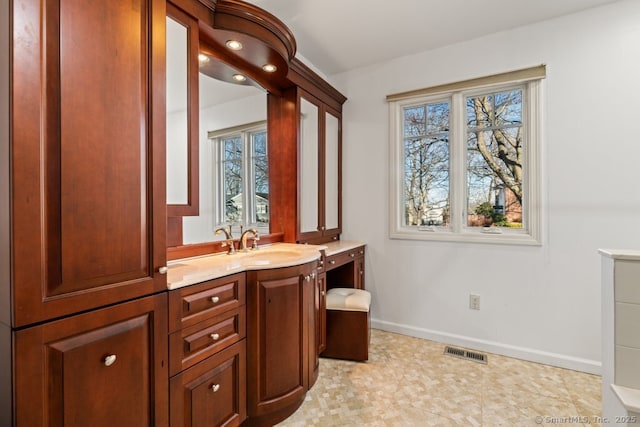 bathroom featuring visible vents, vanity, and baseboards