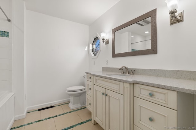 bathroom featuring toilet, tile patterned flooring, a shower, baseboards, and vanity