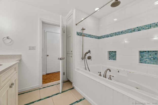 bathroom featuring tile patterned floors, baseboards, vanity, and tiled shower / bath combo